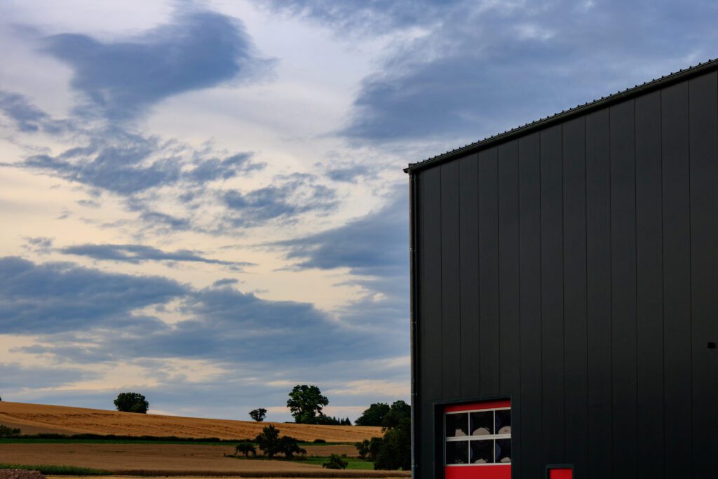 Scenic view of warehouse building against cloudy sunset sky in B