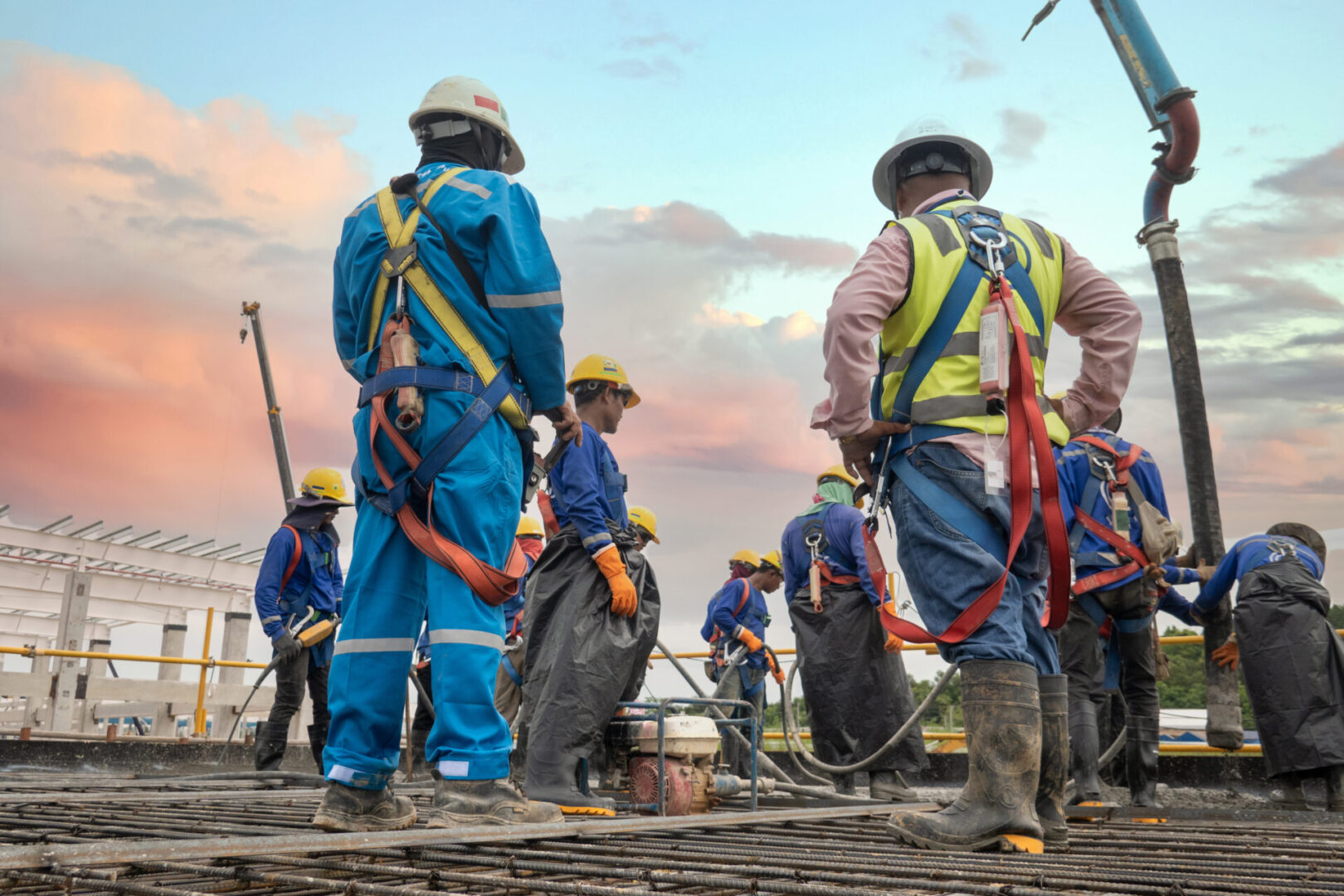 construction worker pouring concrete by pumping