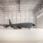 A Grey Color Airplane in a White Interior Warehouse