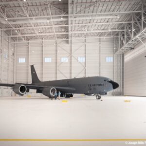A Grey Color Airplane in a White Interior Warehouse