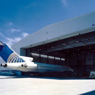 An Airplane Hanger With a White and Blue Airplane