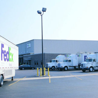 Champaign fed ex truck in front of a building